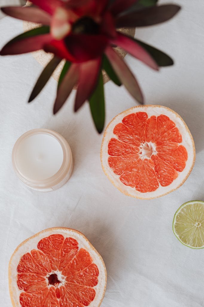 Top view of sliced grapefruit, lemon and skincare product used in Cellulite routine during Menopause